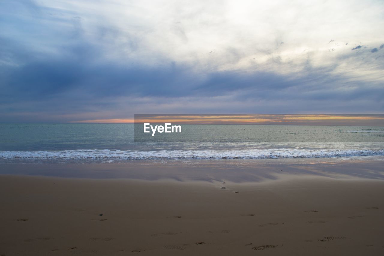 Scenic view of beach against sky during sunset