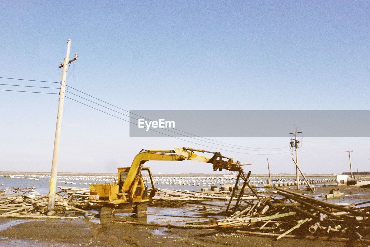 sky, nature, water, construction equipment, industry, no people, day, power generation, clear sky, vehicle, copy space, sea, outdoors, machinery, blue, land, transportation, construction industry, construction site, environment, sunny