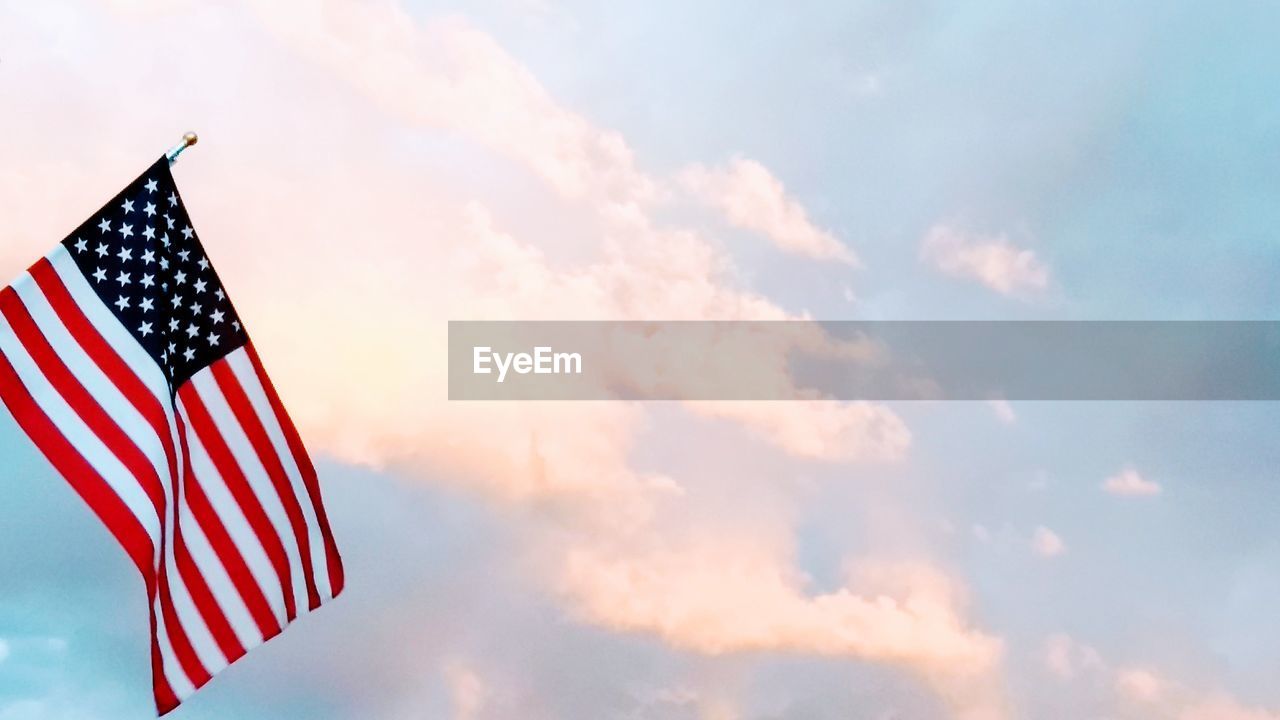 CLOSE-UP OF FLAG AGAINST SKY