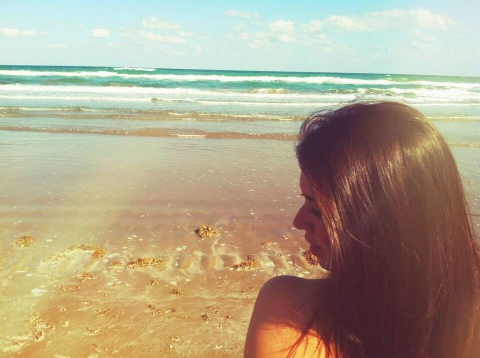 Long-haired woman at seaside