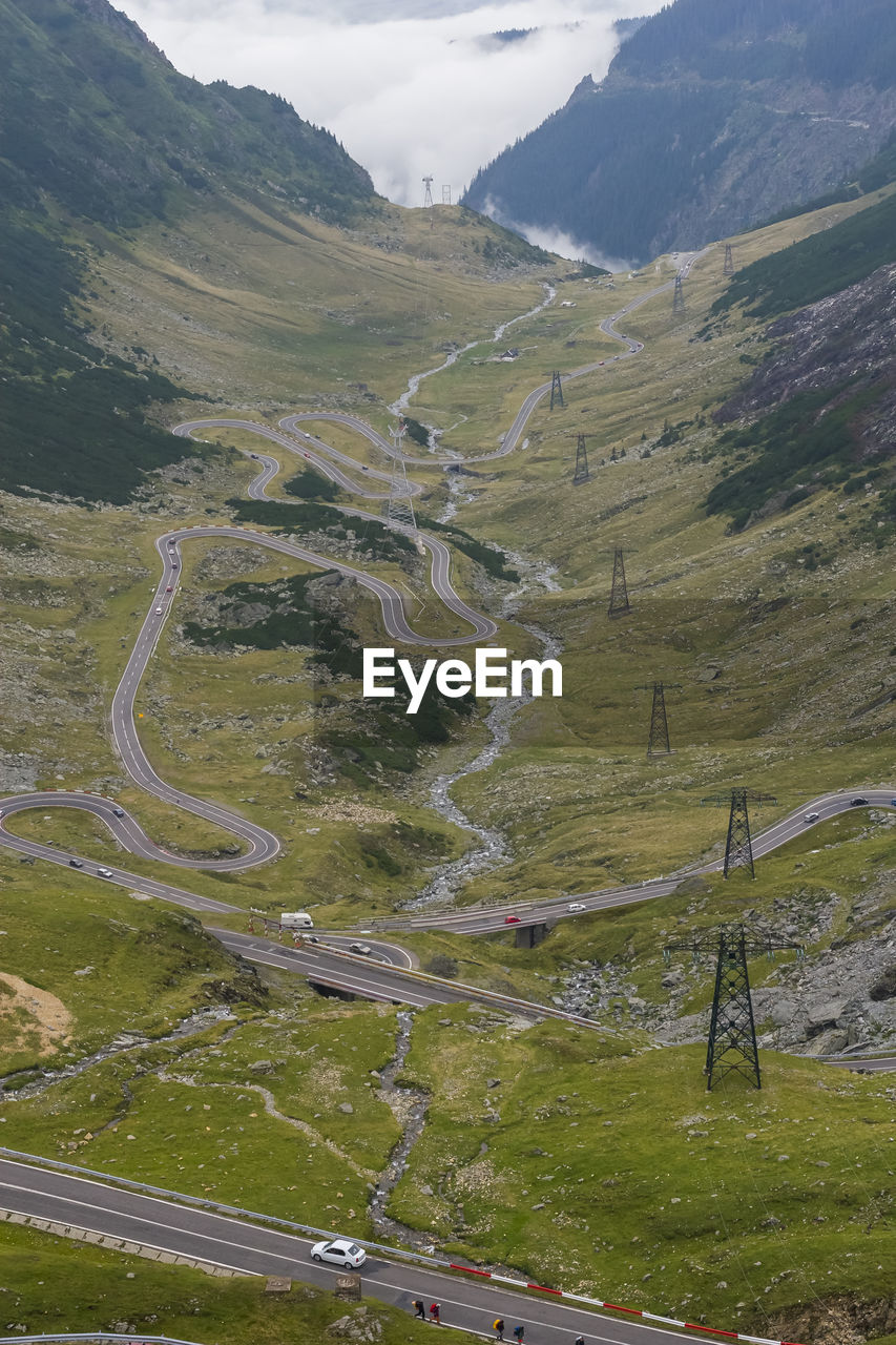 HIGH ANGLE VIEW OF ROAD AMIDST LAND