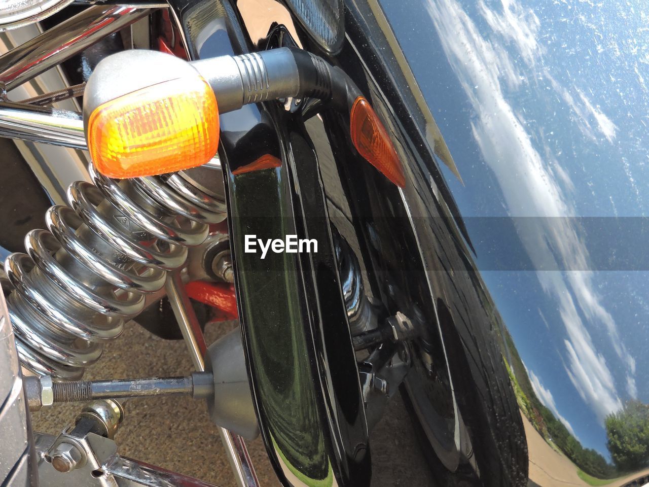 Close-up of motor bike against sky