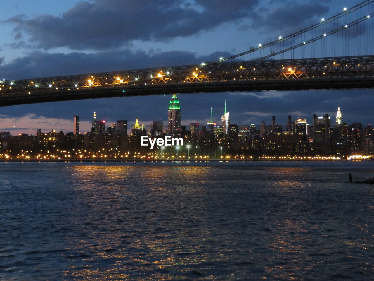 VIEW OF ILLUMINATED CITYSCAPE AT NIGHT