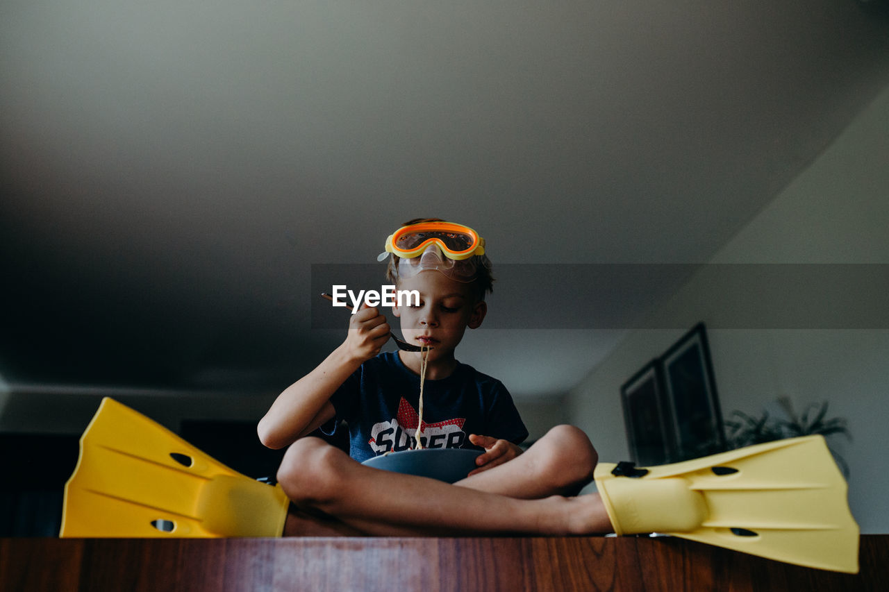 Boy eating food at home