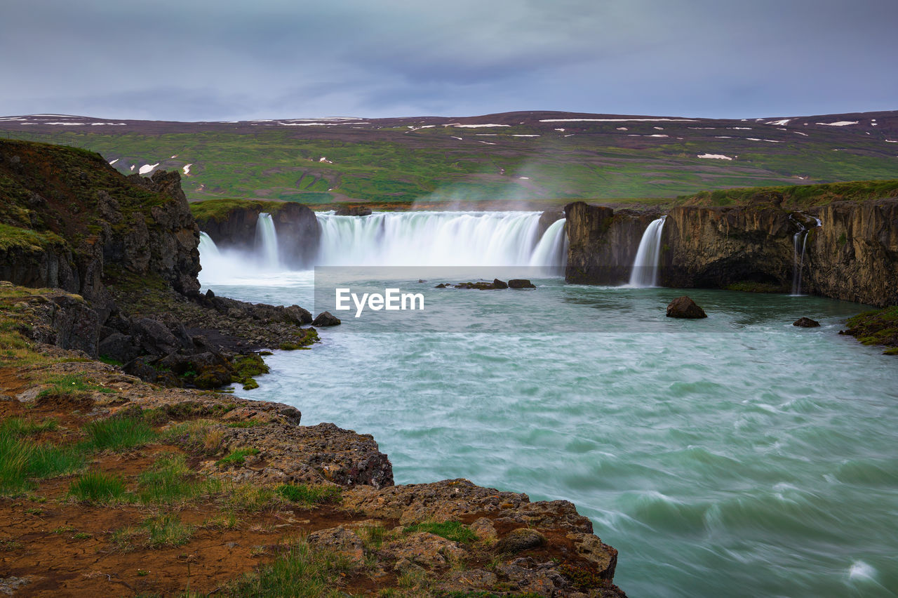 SCENIC VIEW OF WATERFALL AT SEASIDE