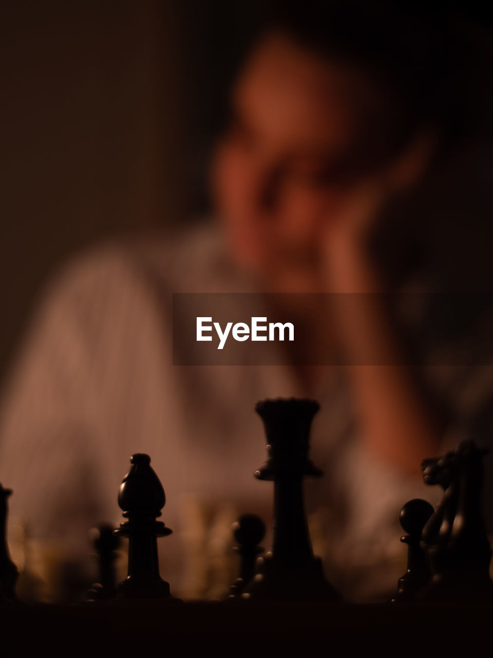 Close-up of chess board with woman in background