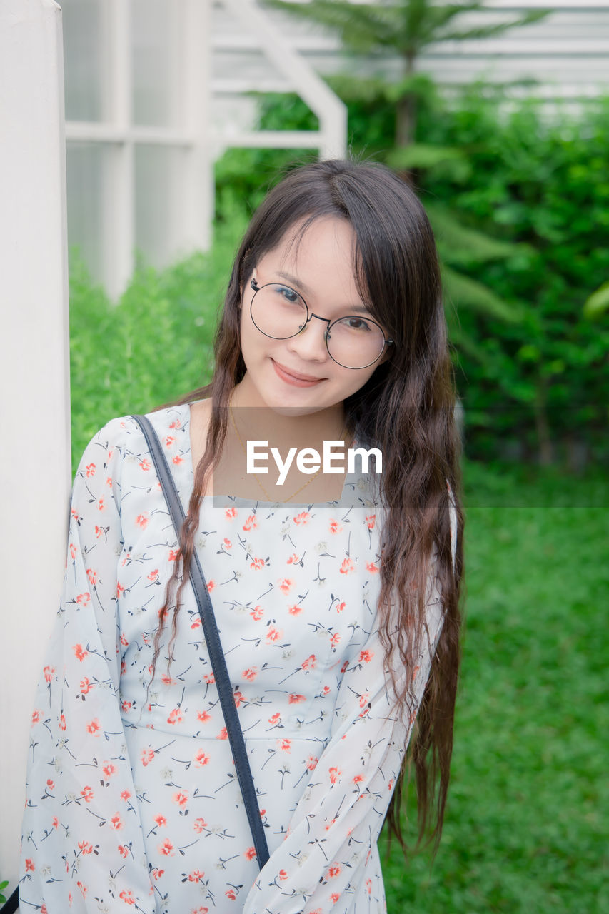 Portrait of smiling young woman standing outdoors