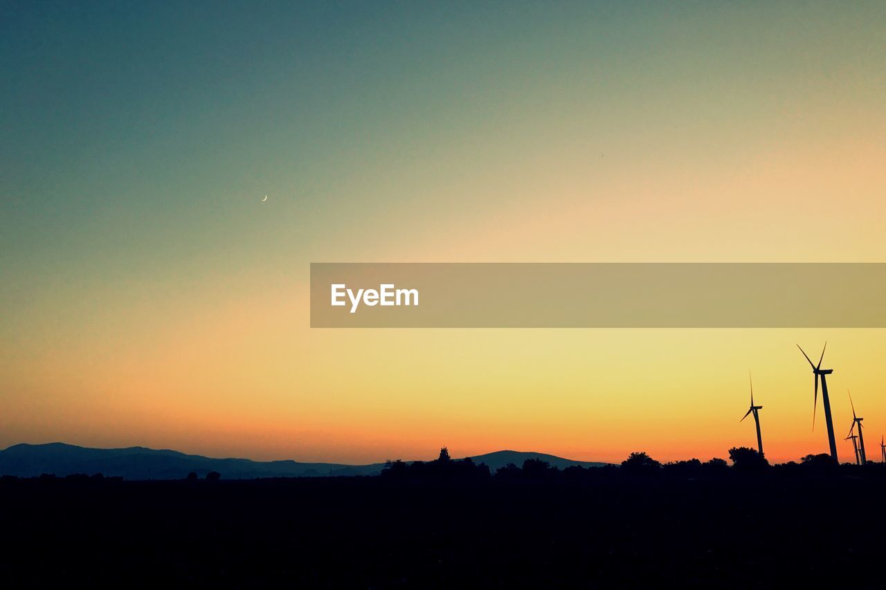 SILHOUETTE OF FIELD AGAINST CLEAR SKY DURING SUNSET