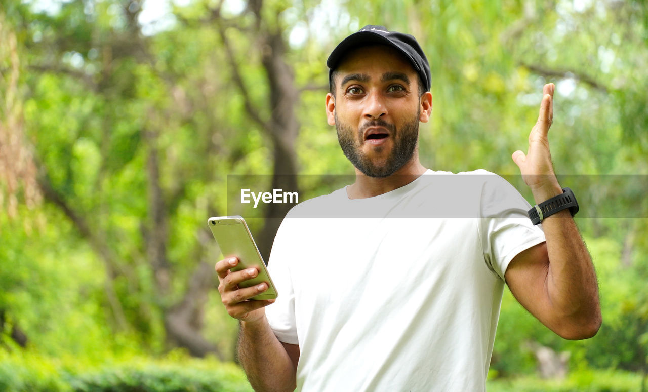 portrait of young man using mobile phone