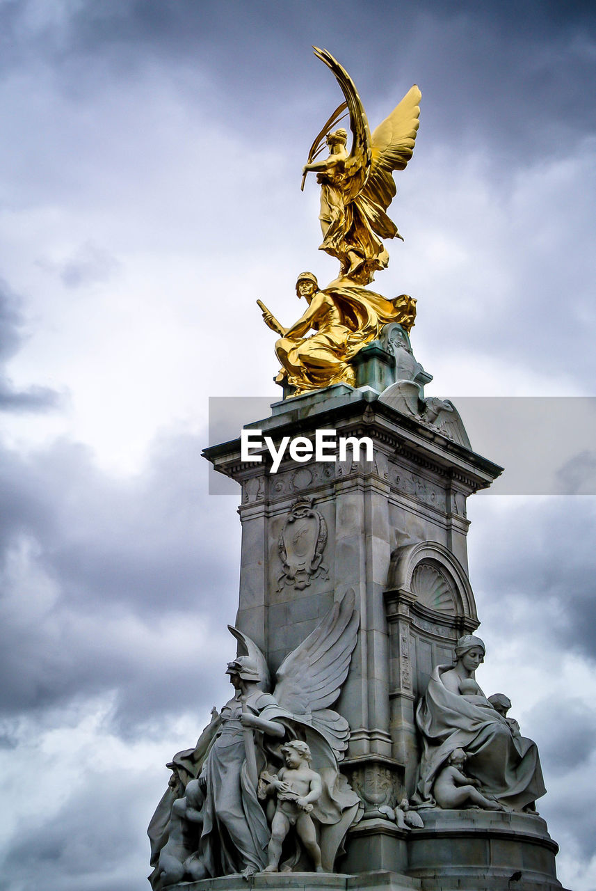 Low angle view of statue against cloudy sky