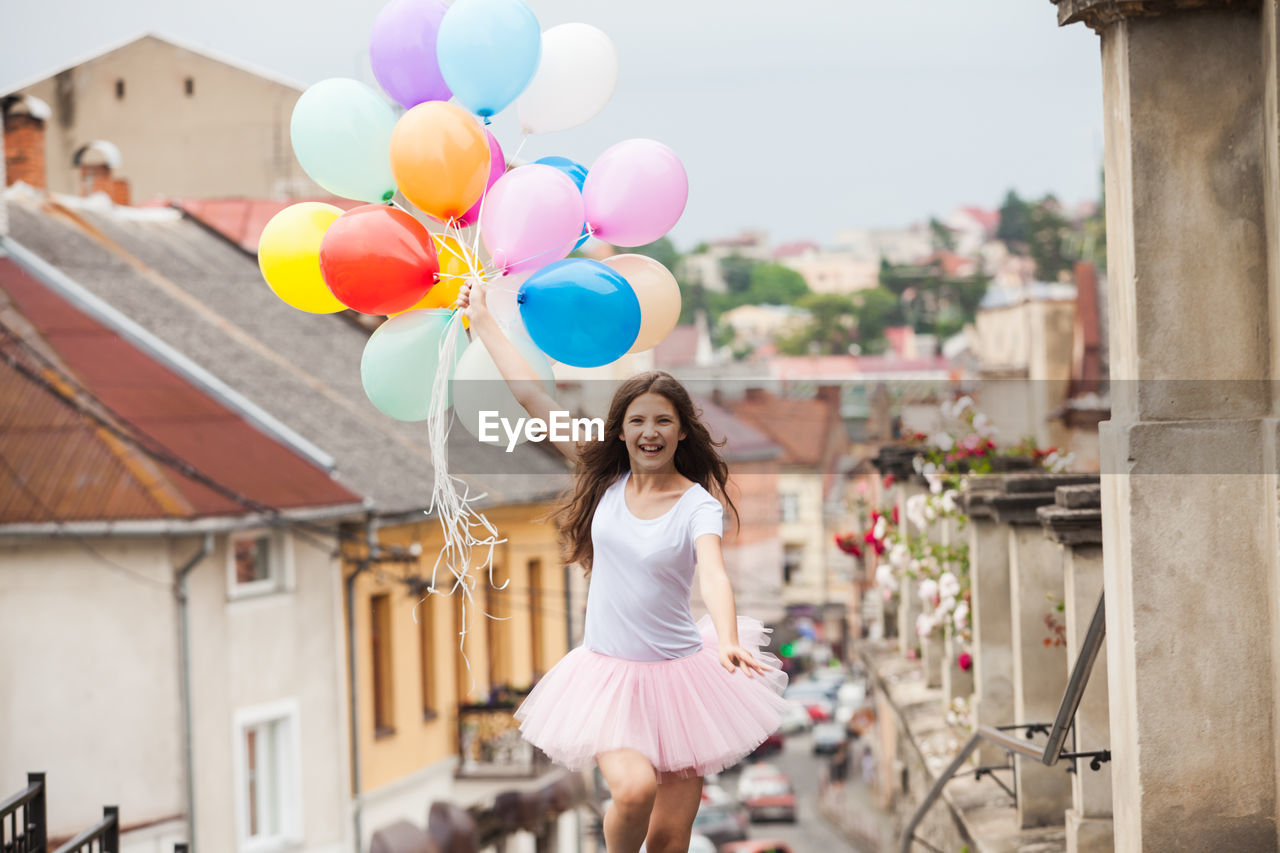 Woman holding balloons