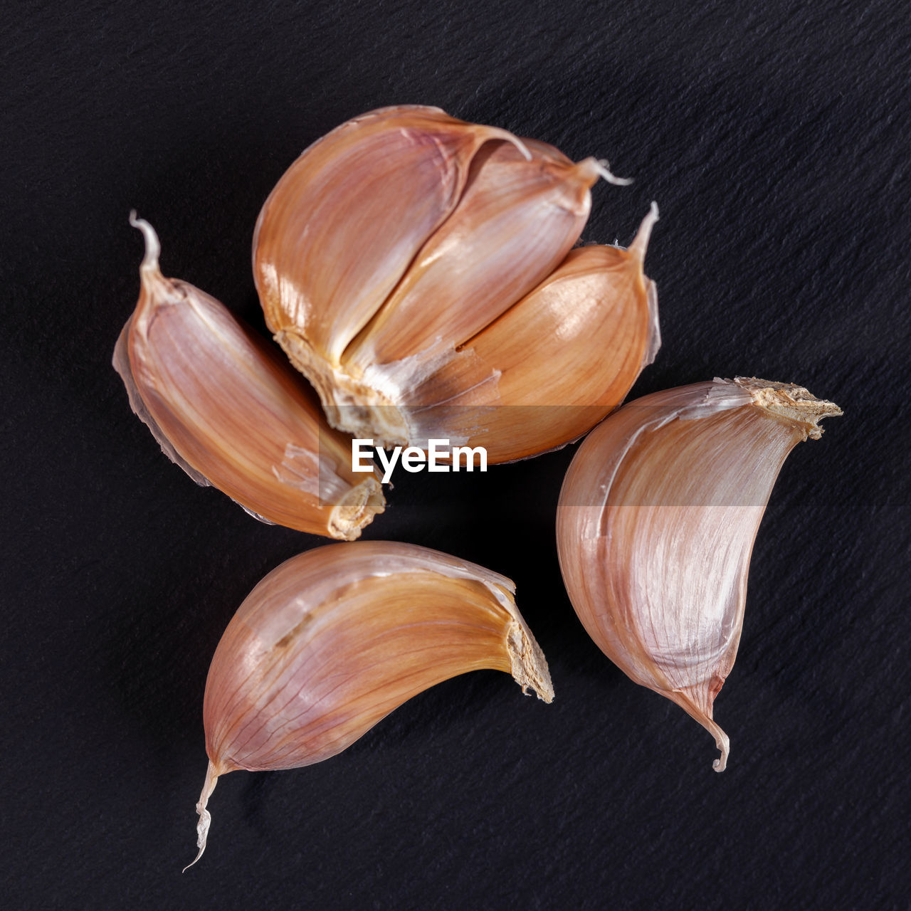 food and drink, food, freshness, ingredient, wellbeing, healthy eating, produce, garlic, studio shot, indoors, still life, no people, black background, shallot, spice, vegetable, close-up, garlic clove, high angle view, onion, group of objects, garlic bulb, flower, raw food