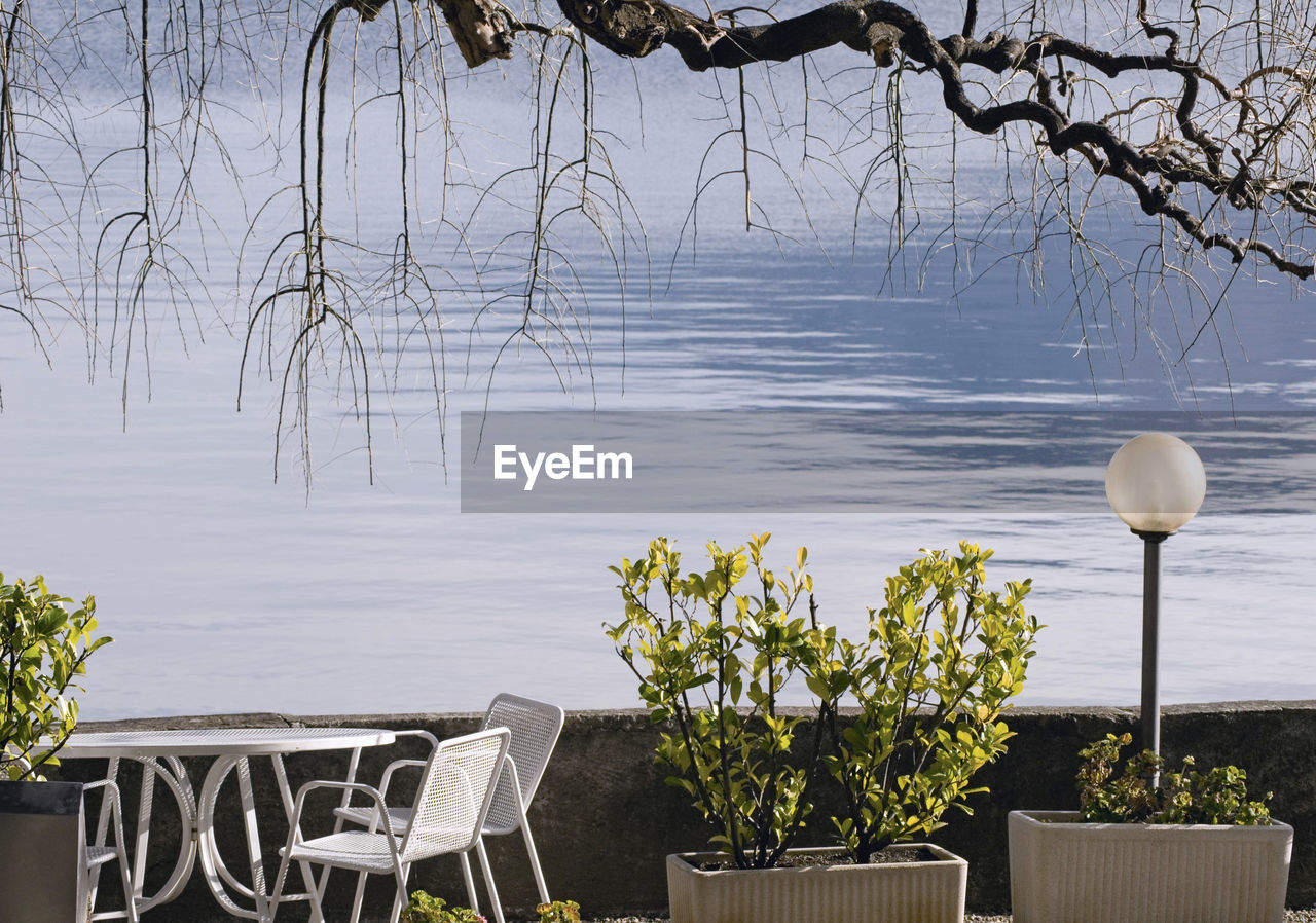 SCENIC VIEW OF LAKE AGAINST CLOUDY SKY AT SUNSET