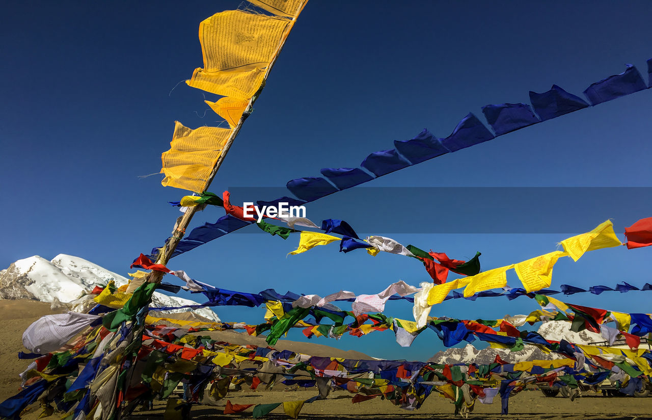 Praying flags hanging against sky