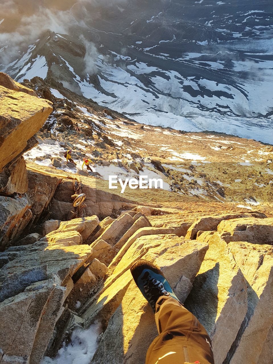 Low section of person standing on rock at matterhorn