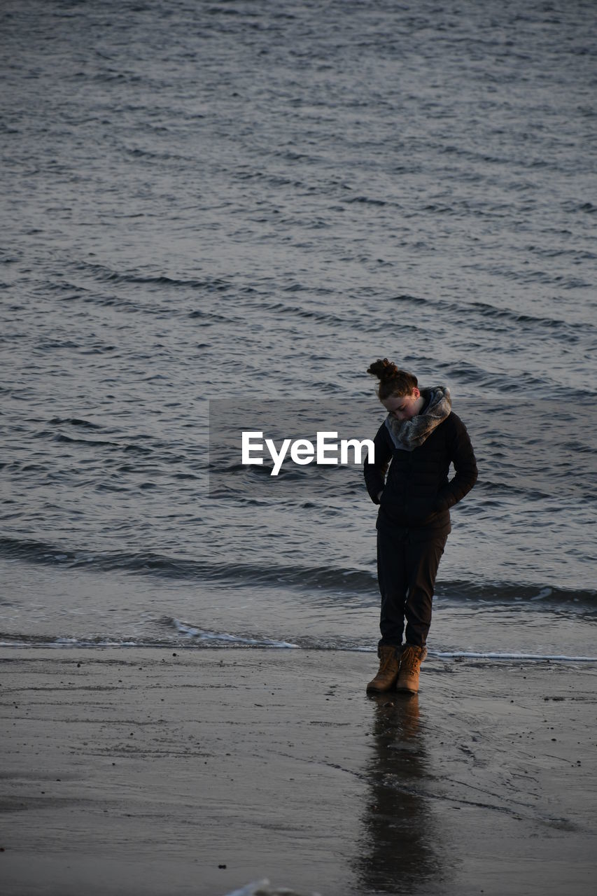 Full length of woman standing at beach