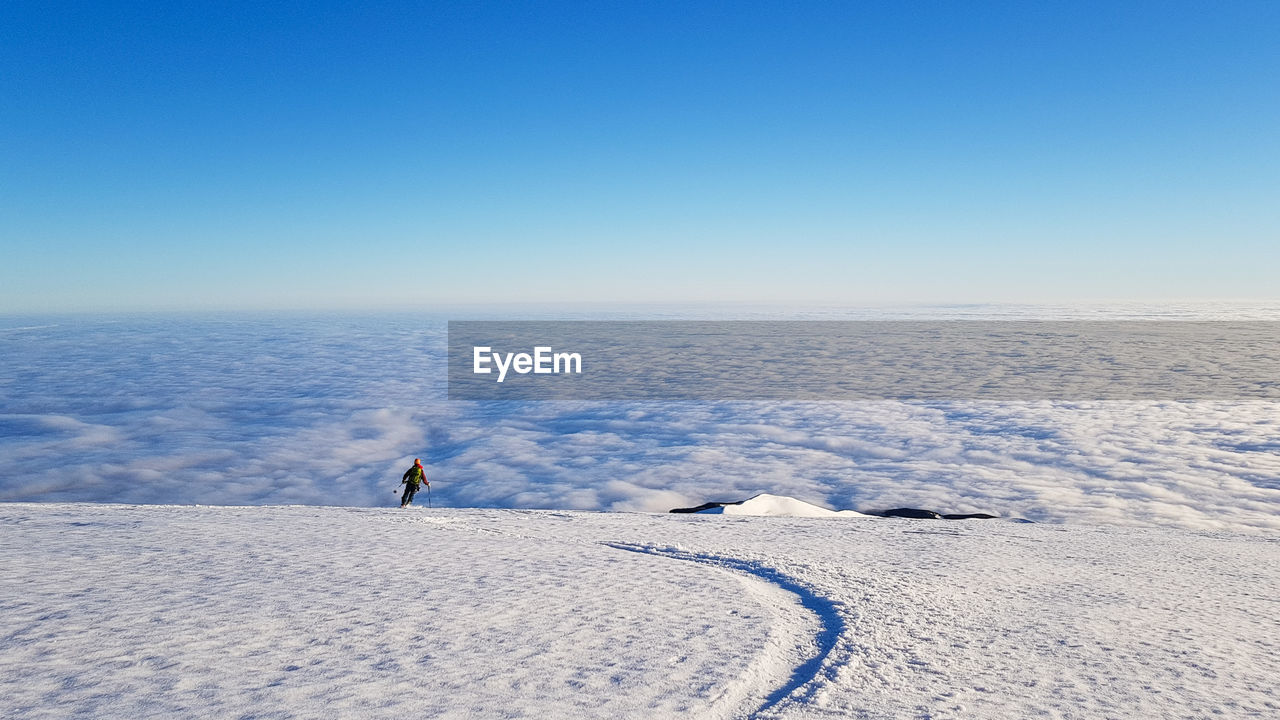 Scenic view of snowcapped landscape against clear blue sky