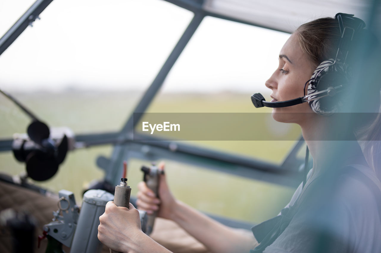 Female pilot sitting at the wheel of the plane