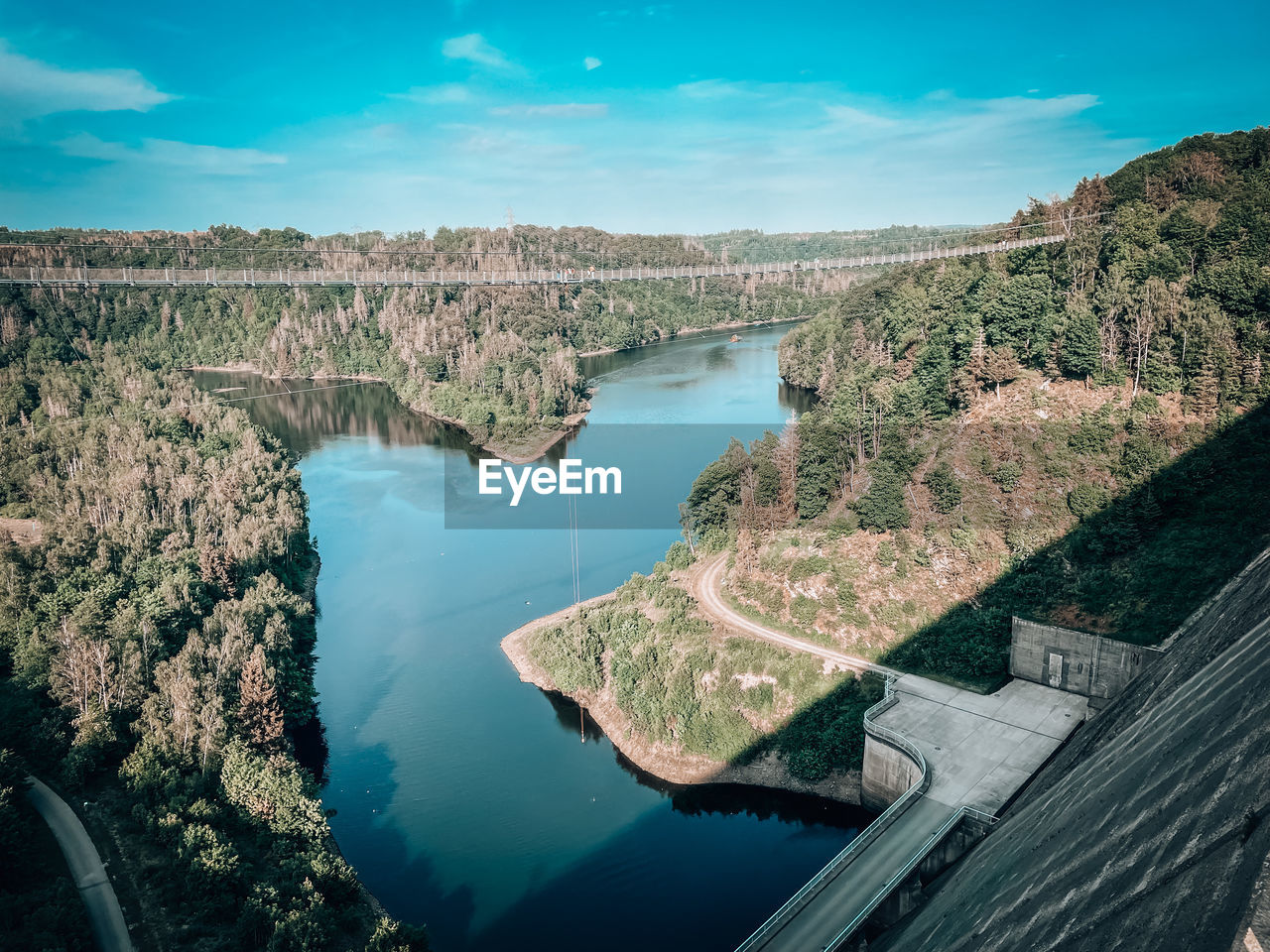 water, environment, landscape, nature, scenics - nature, aerial photography, reflection, sky, travel destinations, travel, land, reservoir, beauty in nature, aerial view, no people, blue, river, architecture, tourism, outdoors, high angle view, environmental conservation, coast, tree, cloud, tranquility, built structure, day, plant, non-urban scene, mountain, dam, terrain, tranquil scene