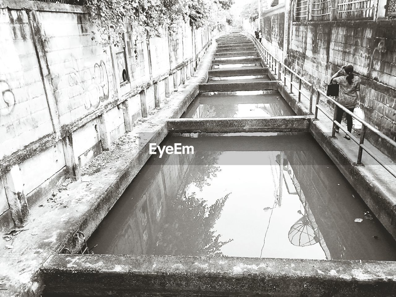 HIGH ANGLE VIEW OF WATER REFLECTION ON ROAD