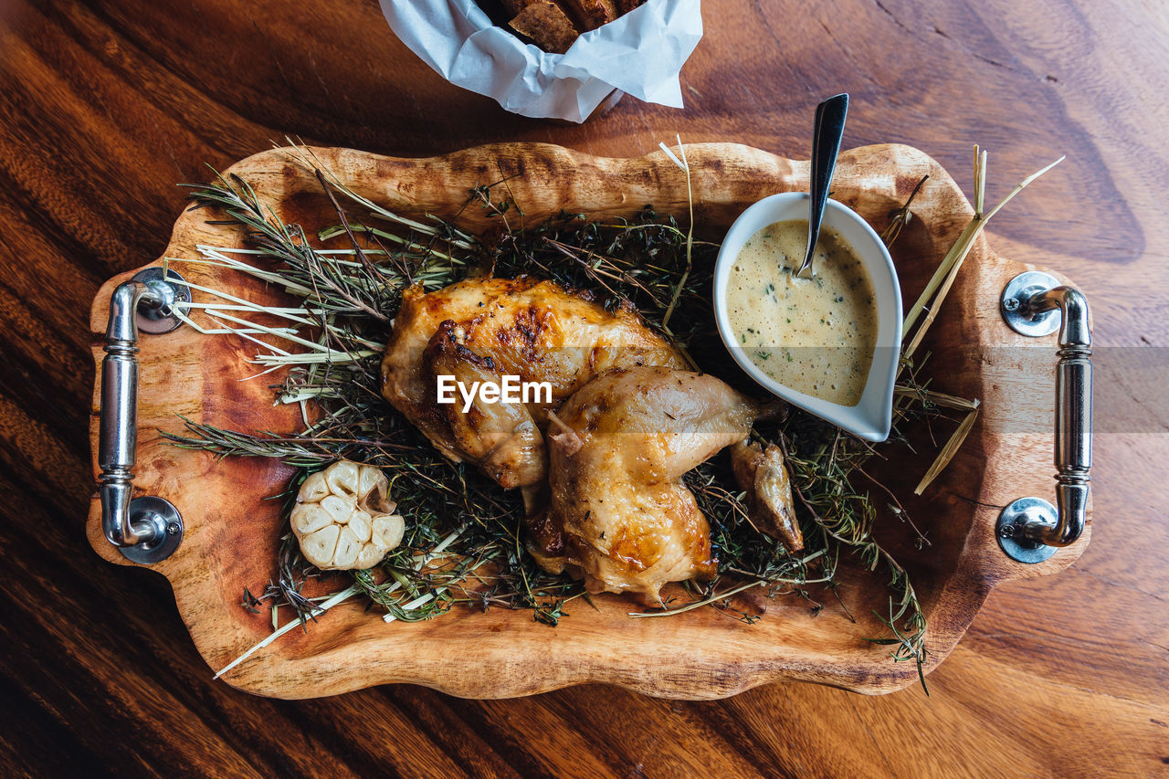 High angle view of chicken with dip served on table