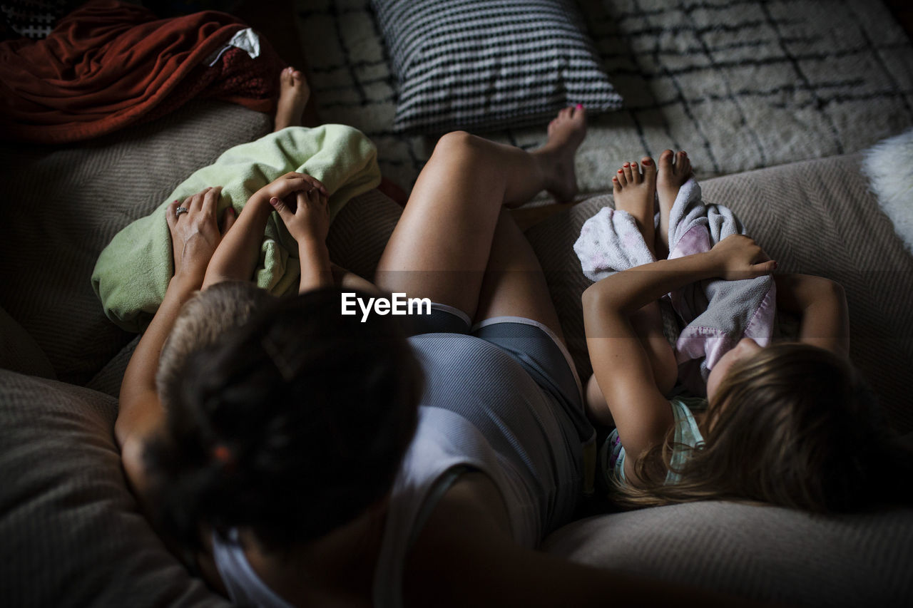 High angle view of mother with children on sofa