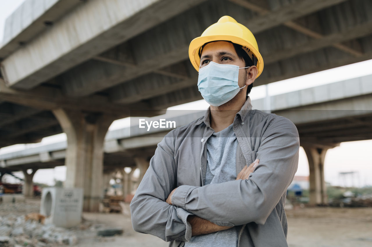 Portrait of man standing against built structure