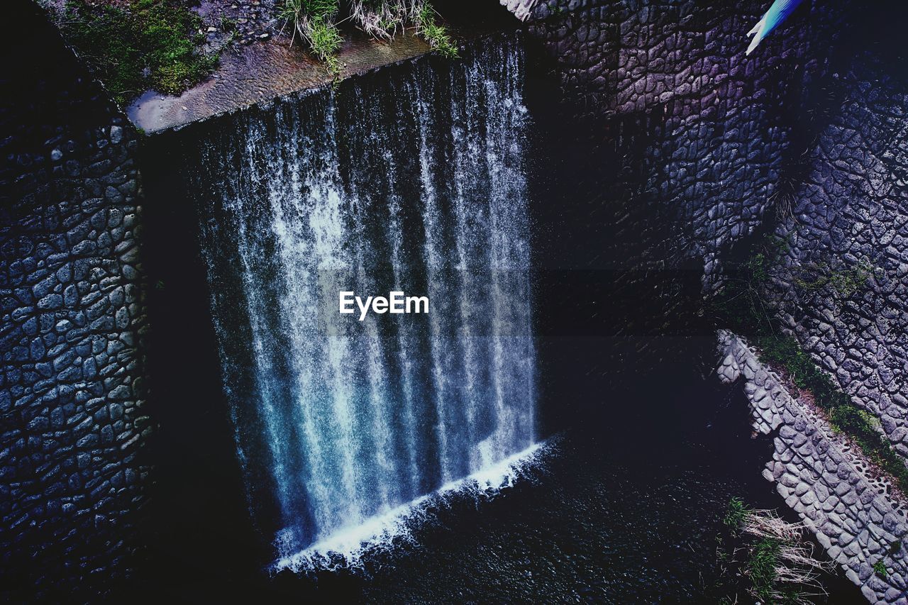 High angle view of water flowing through wall