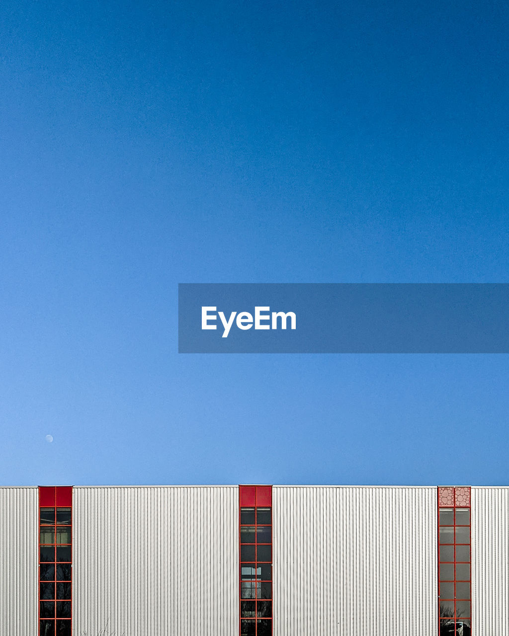 Low angle view of building against clear blue sky