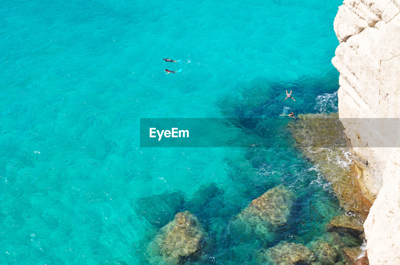 High angle view of people swimming in sea