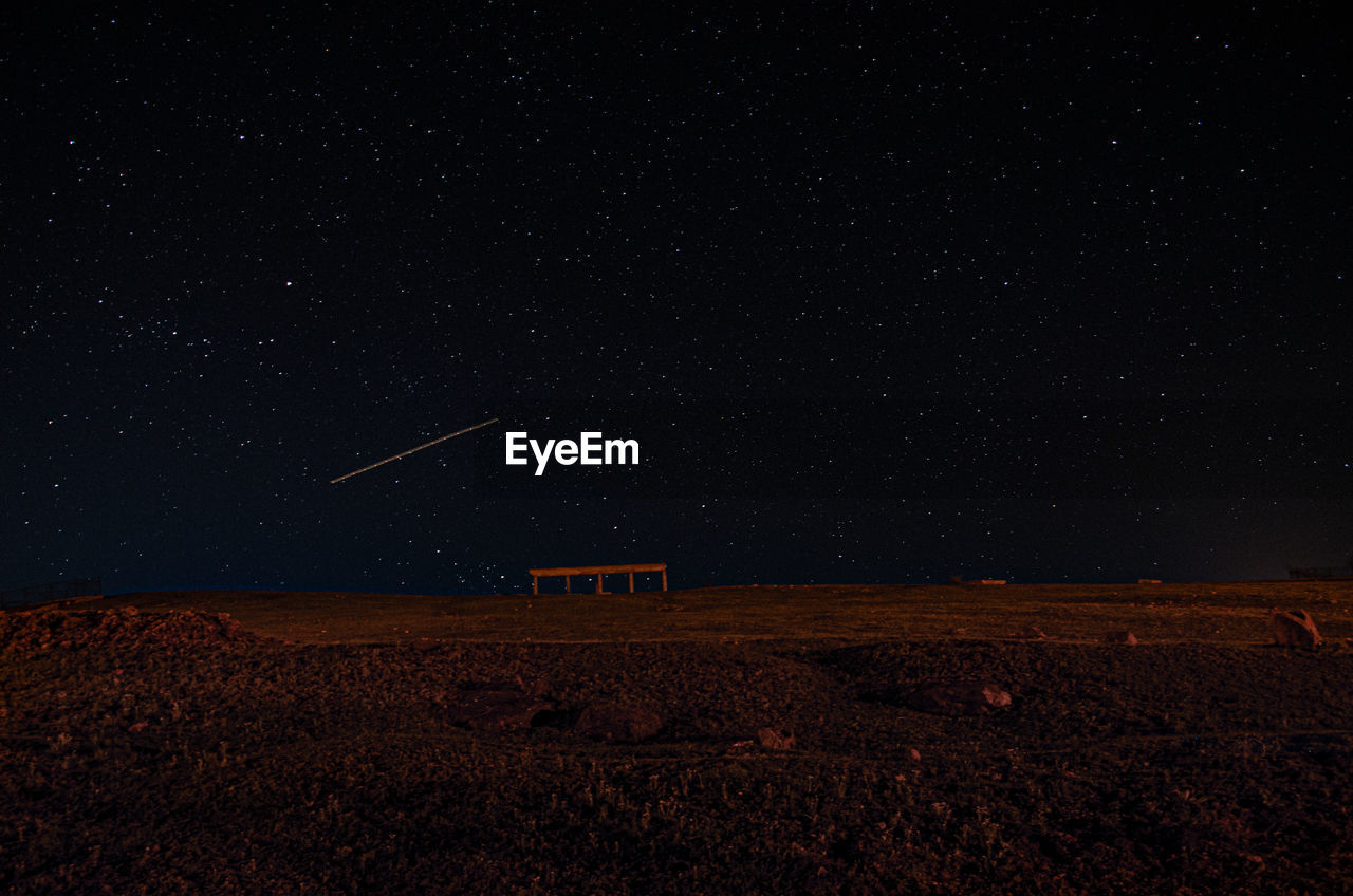 Scenic view of landscape against sky at night