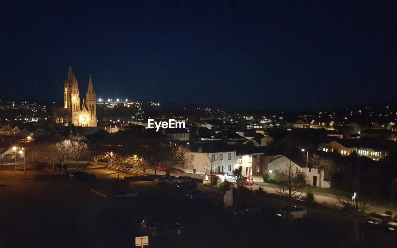 VIEW OF ILLUMINATED CITYSCAPE AT NIGHT