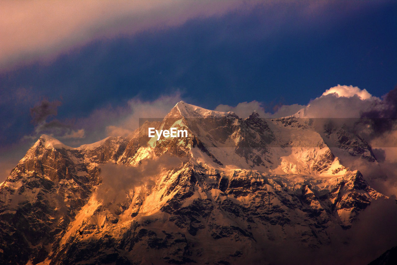 Aerial view of snowcapped mountain against sky during winter