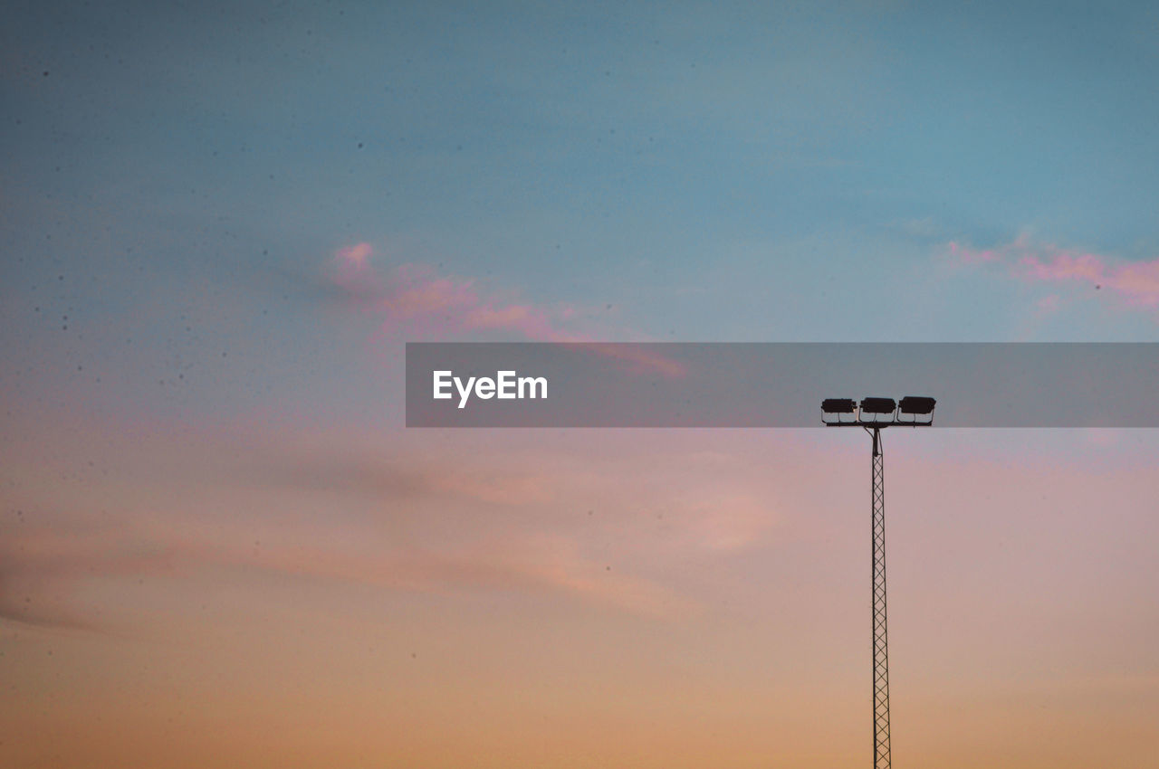 Low angle view of street light against sky during sunset