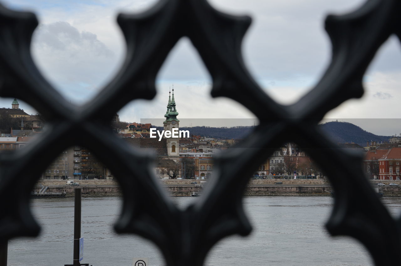 Buildings in front of river seen through patterned window