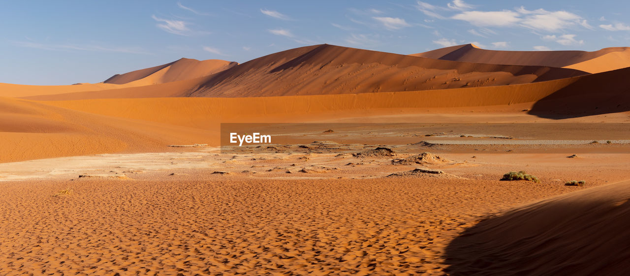 SCENIC VIEW OF SAND DUNES IN DESERT AGAINST SKY