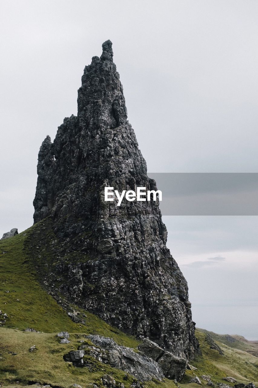 Low angle view of cliff against sky