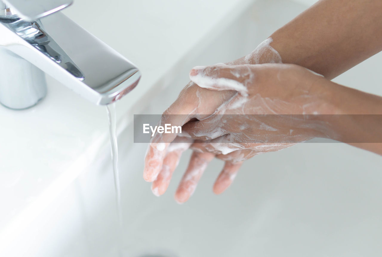 Woman washing hands in sink