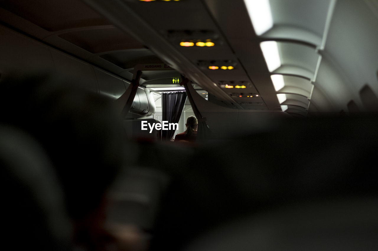 Rear view of air hostess in airplane