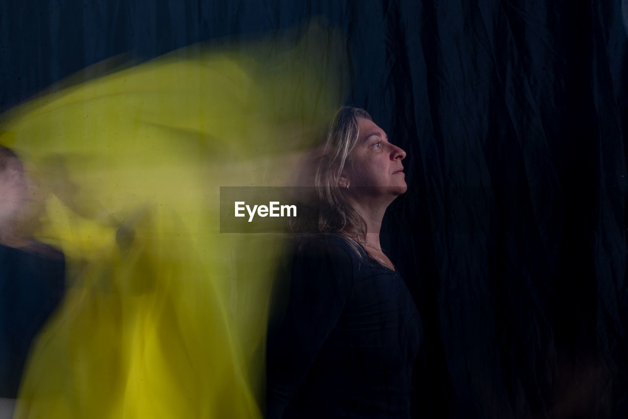 Time lapse view of woman moving a rag. long exposure, motion blur. 