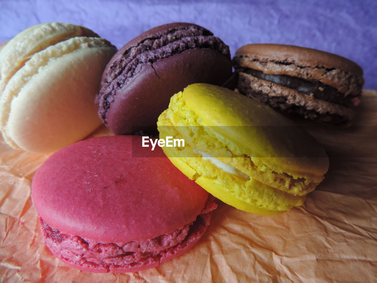 Close-up of colorful macaroons on wax paper