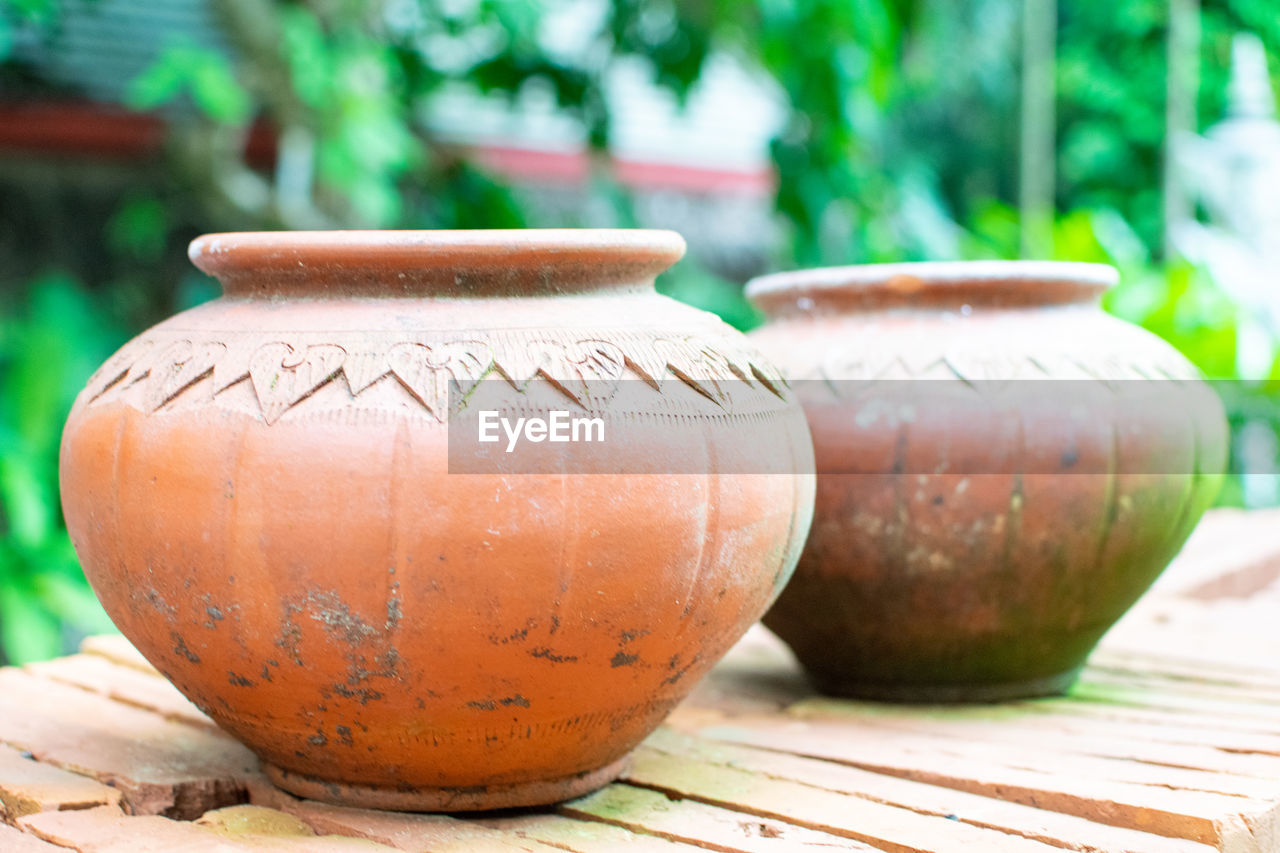 pottery, ceramic, craft, earthenware, clay, art, wood, terracotta, focus on foreground, nature, no people, outdoors, food and drink, tradition, plant, day, close-up, porcelain