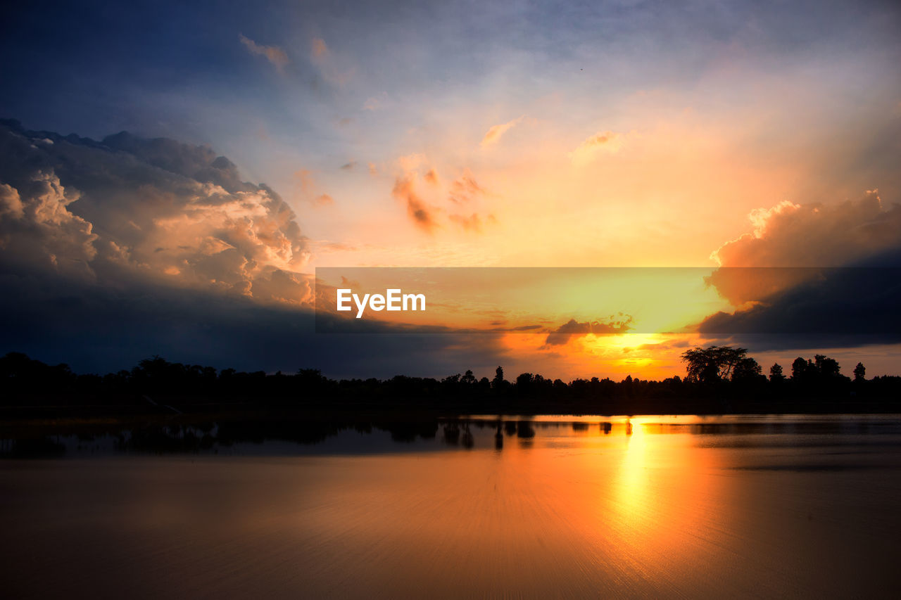 Scenic view of lake against romantic sky at sunset