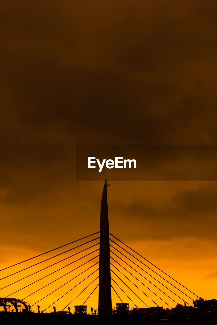 LOW ANGLE VIEW OF SILHOUETTE BRIDGE AGAINST SKY