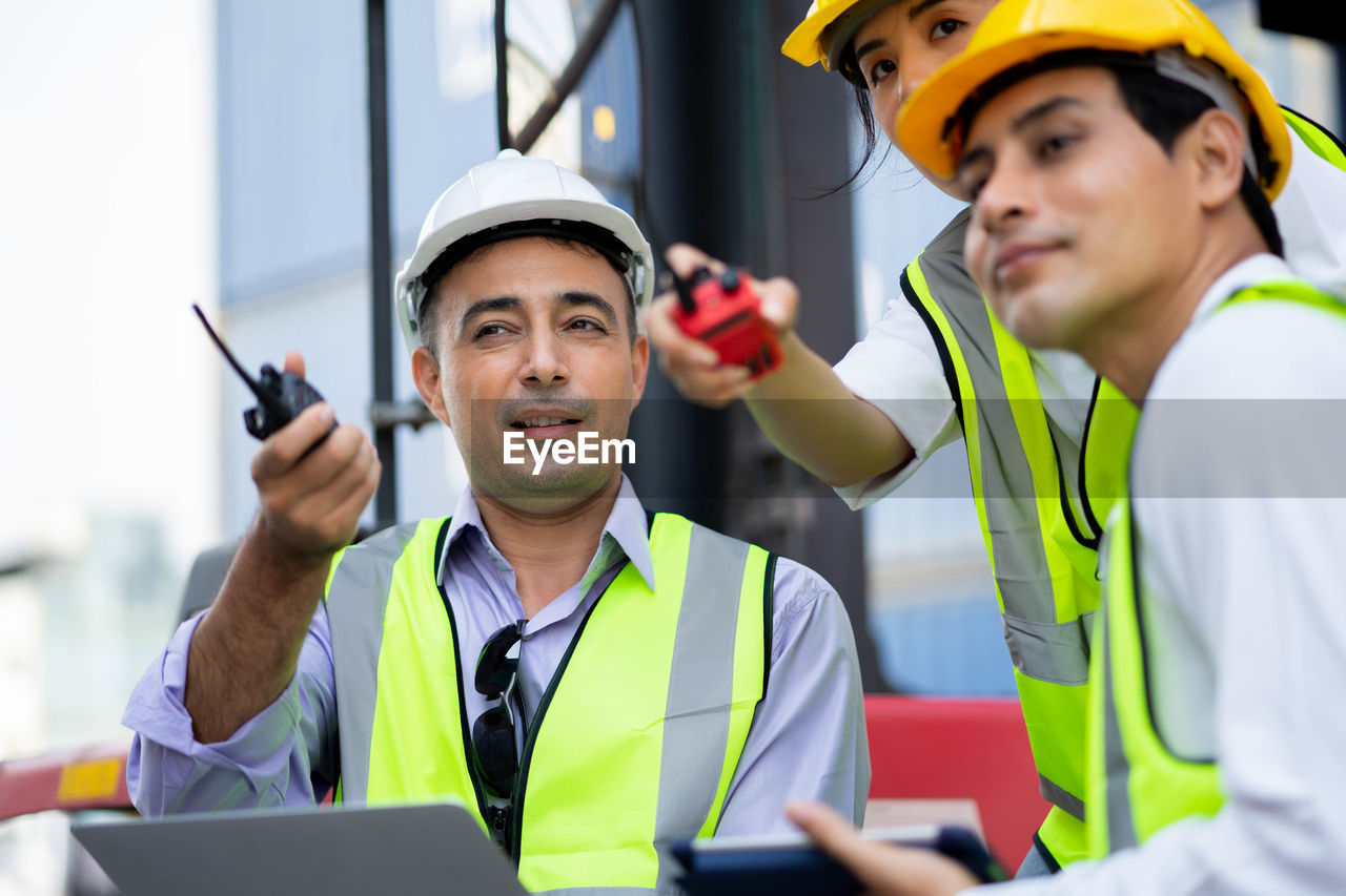 PORTRAIT OF A MAN WORKING WITH MOBILE PHONE