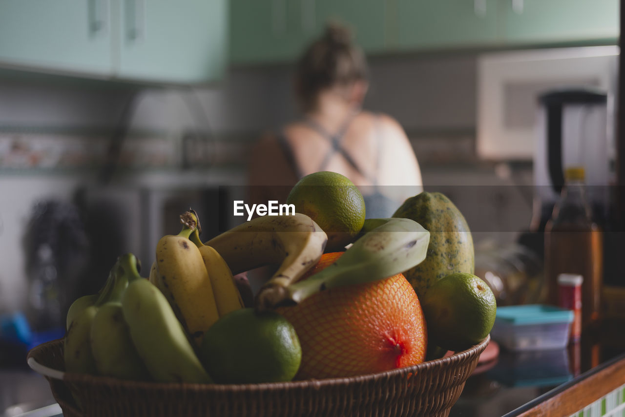 Caucasian woman with her back to her cooking in the kitchen. 