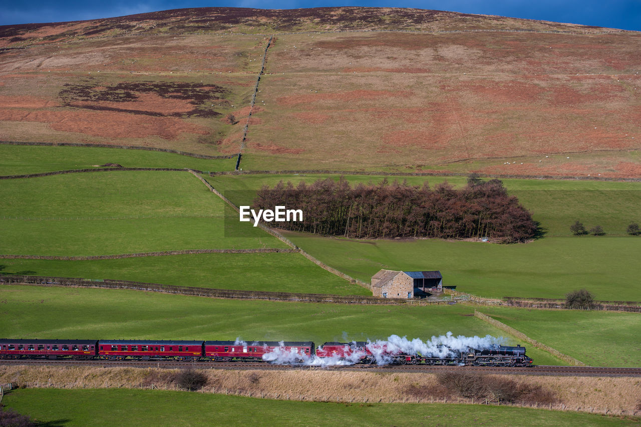 Side view of steam engine train on landscape