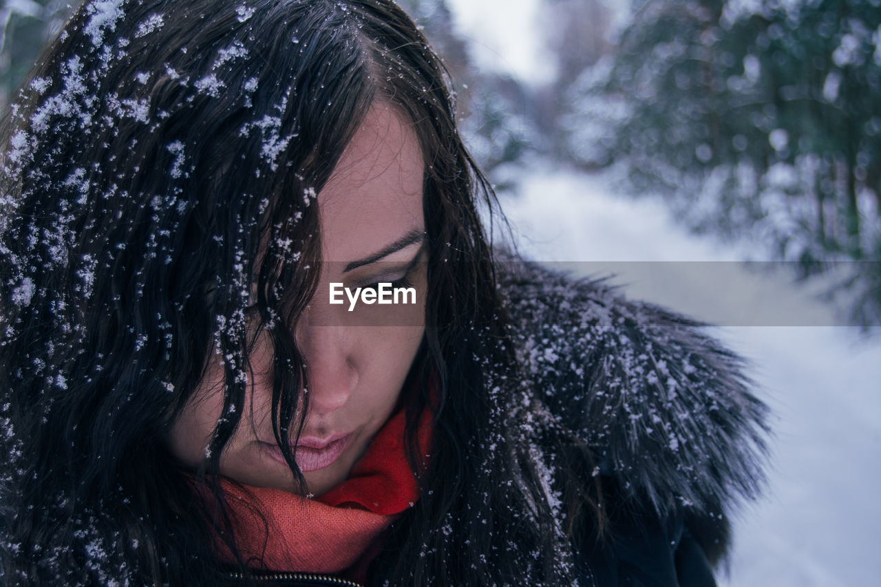 Close-up of young woman against sky