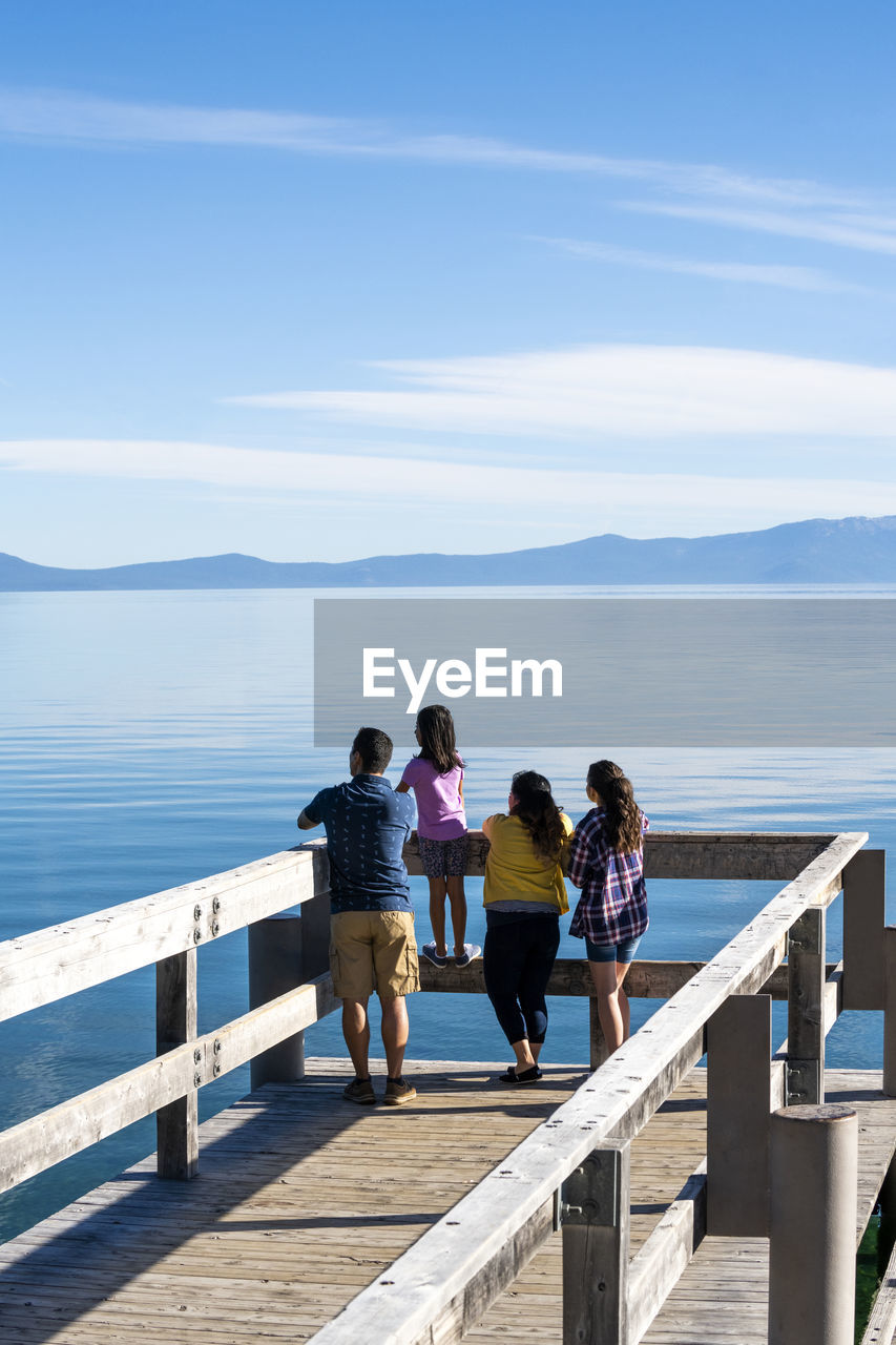 A family enjoying a pier on a beautiful day in south lake tahoe, ca