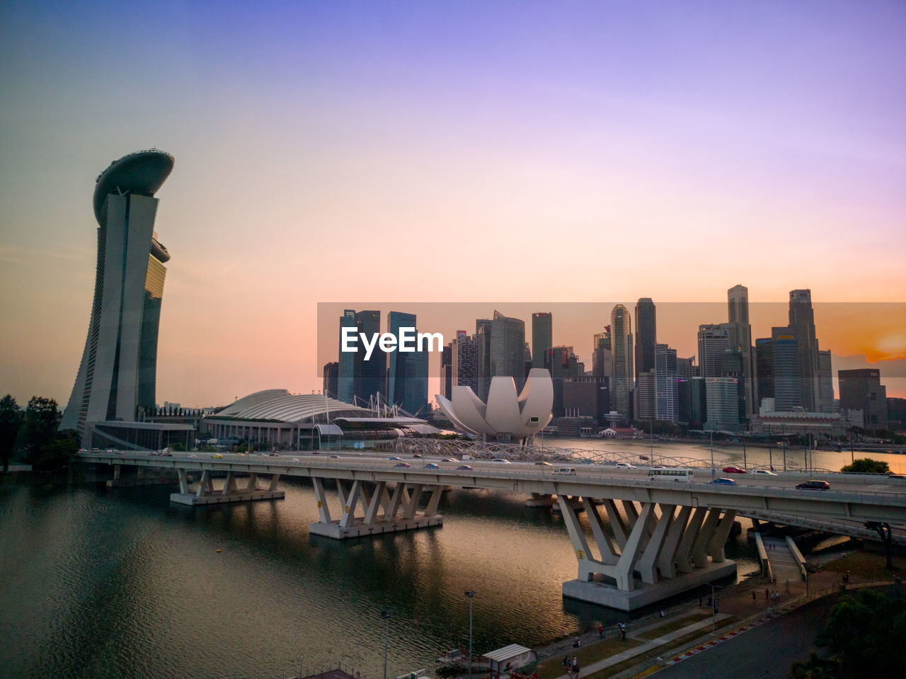 Modern buildings in city against sky during sunset